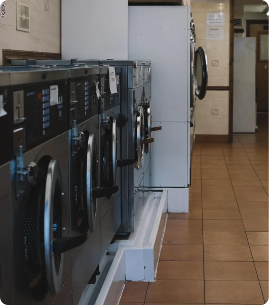 A row of washing machines in a laundry room.